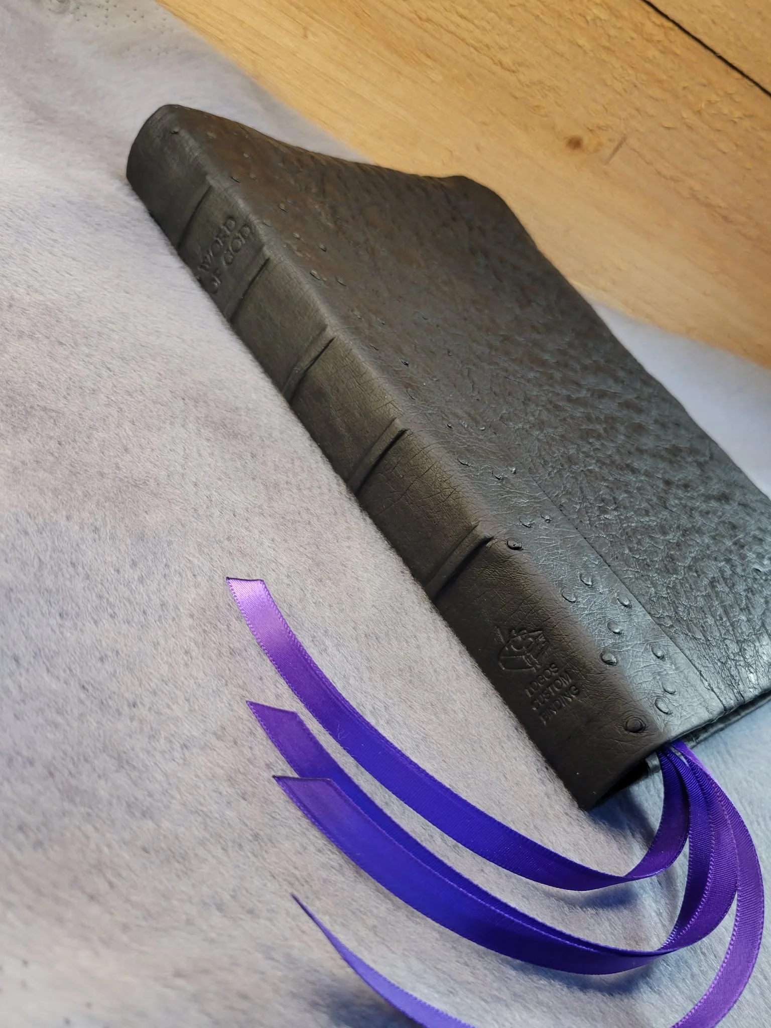 Dual leather black oily ostrich with raised ribs.