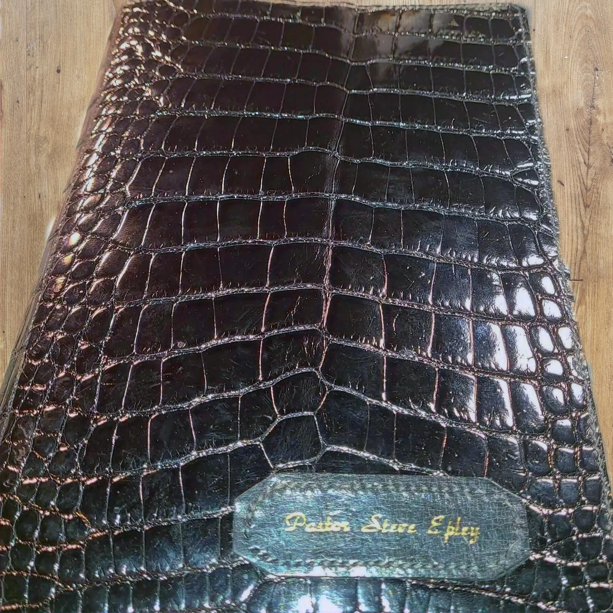 Black textured leather Bible cover with a personalized inset panel.