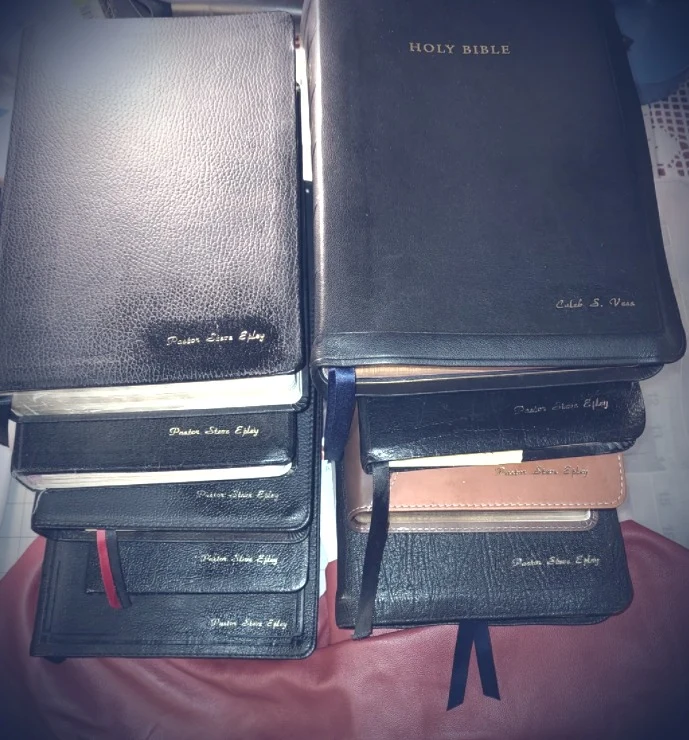Alternate view: Stacked custom Bibles with leather covers, gold imprinting, and colorful ribbon markers.